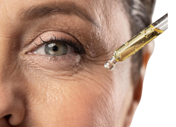 Picture shows the eye of a mature lady with serum being applied.