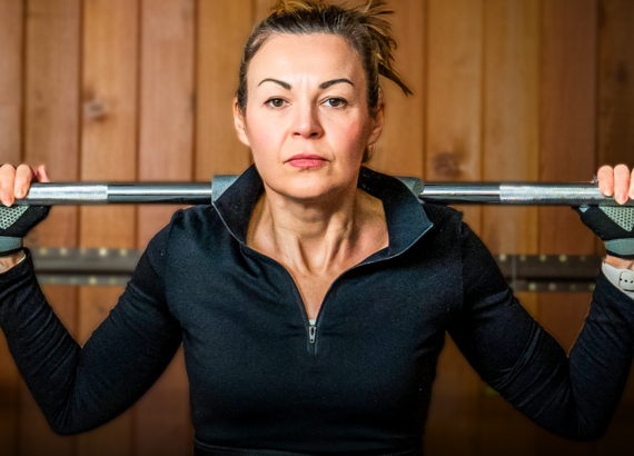 Clare Johnston squats with a barbell